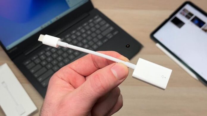Holding Apple USB-C to USB Adapter